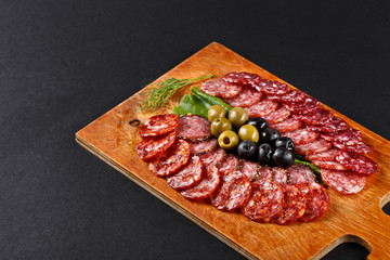 assortment smoked sausage slices on cutting board