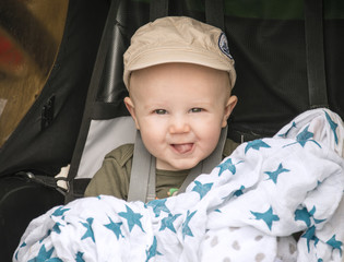 Happy Baby in Cap Goes for a Bike Ride in a Carrier