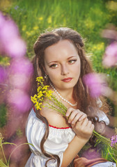 Beautiful young woman with flowers