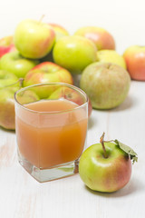 Glass of apple juice and green apples