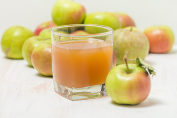 Glass of apple juice and green apples