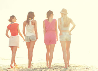 group of young women walking on beach