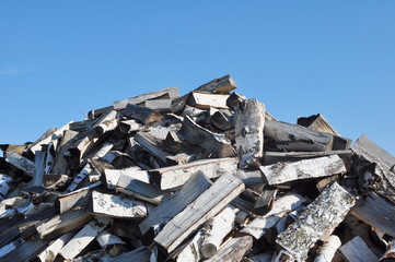 Pile of Firewood and Blue Sky