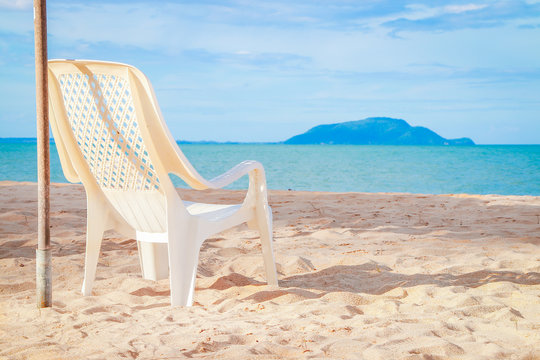 Beach chair on sand beach for relaxation.