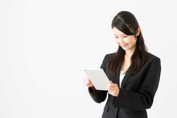 asian businesswoman using tablet on white background