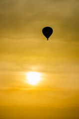 Silhouette hot air balloon on yello sky sunset