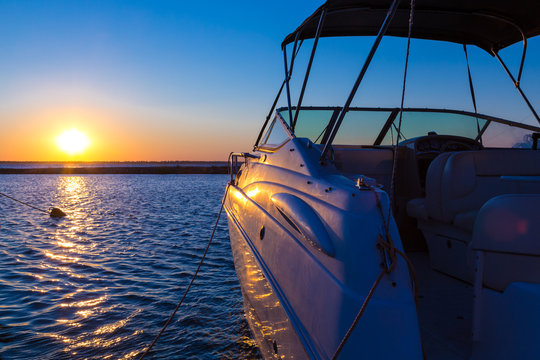 Yacht near the pier against sunset
