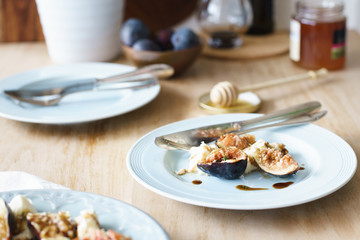Closeup of summer appetizer: mozzarella and fresh figs with dressing of balsamic vinegar, olive oil and honey