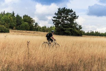 Biking in the Franconian Hills in Northern Bavaria. Young man on