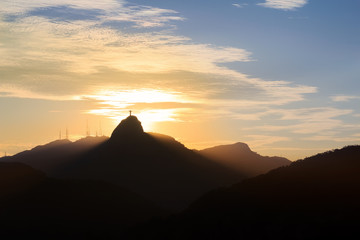 Sunset behind Mountain Corcovado Christ the Redeemer, Rio de Jan