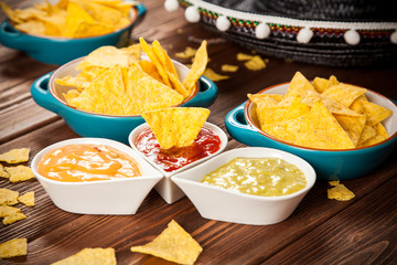 Plate of nachos with different dips