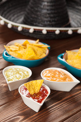 Obraz na płótnie Canvas Plate of nachos with different dips