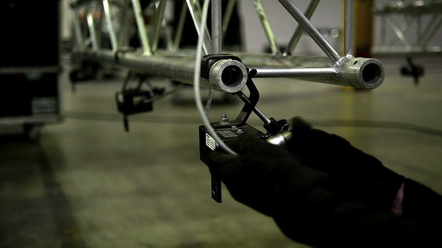 Man installed a stage frame with light effects. 