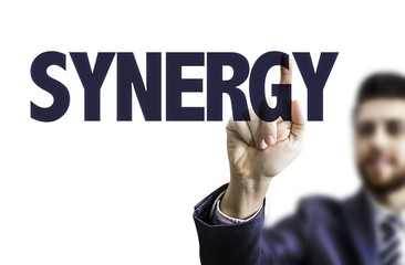 Business man pointing the text: Synergy