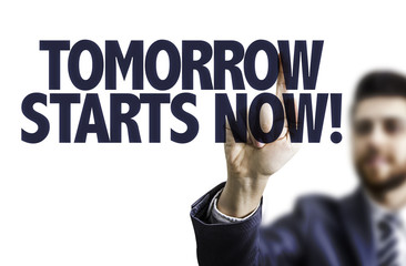 Business man pointing the text: Tomorrow Starts Now