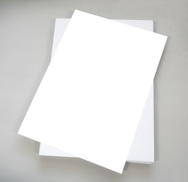 white plain office paper on grey background, blank paper