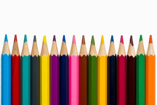 lined colorful pencils on white background