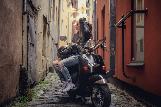 Casual girl on moto scooter.