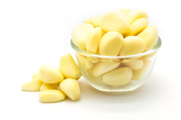 Fresh garlic in glass bowl on white