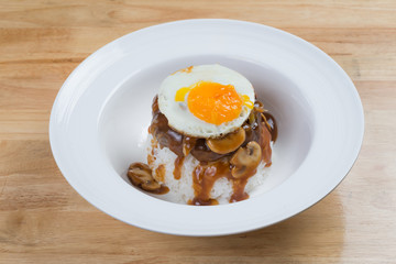 Steamed rice with fried egg and mushroom sauce