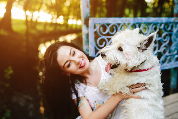 girl playing with a dog