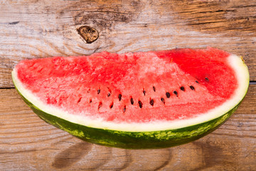Slices of watermelon on old wooden background