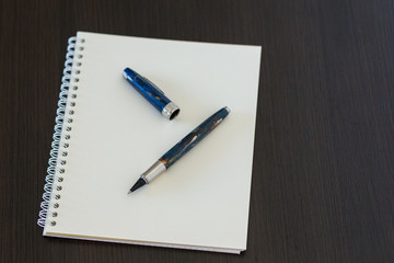 Blank notepad on office wooden table