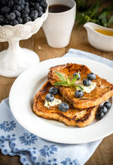 French toasts with fresh blueberries and maple syrup