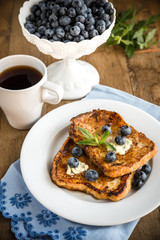 French toasts with fresh blueberries and maple syrup