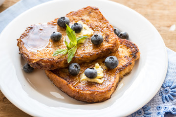 French toasts with fresh blueberries and maple syrup