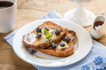 French toasts with fresh blueberries and maple syrup