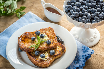 French toasts with fresh blueberries and maple syrup