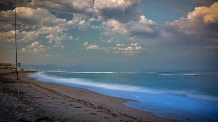 evening calmness on the beach with blurred people and vignetting