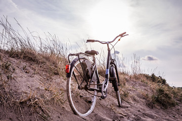 bicycle on a beach during teh sunset