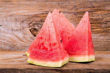 Slices of watermelon on old wooden background