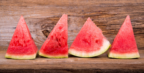 Slices of watermelon on old wooden background