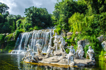 2 kilometers long promenade leading through gardens of imperial palace in caserta is decorated by many fountains and statues from bernini and ends by artificial waterfall. - obrazy, fototapety, plakaty