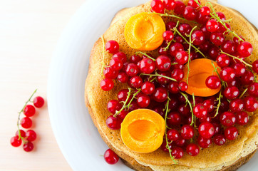 Pancakes with berries and fruits: apricot, red, blackcurrant
