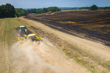 Tractor harrowing the field in fire