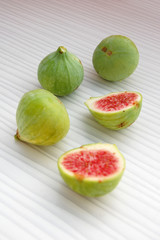 fresh fruits background with figs on white table