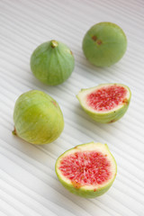 fresh fruits background with figs on white table