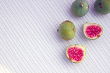 fresh fruits background with figs on white table