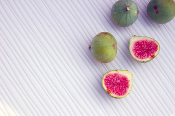 fresh fruits background with figs on white table