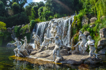 2 kilometers long promenade leading through gardens of imperial palace in caserta is decorated by many fountains and statues from bernini and ends by artificial waterfall. - obrazy, fototapety, plakaty