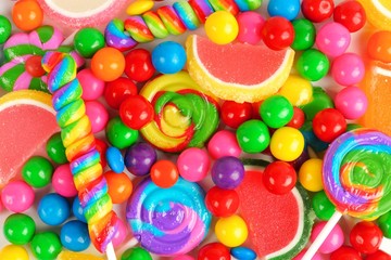 Fototapeta na wymiar Colorful background of assorted candies including gum balls, lollipops and jelly candies