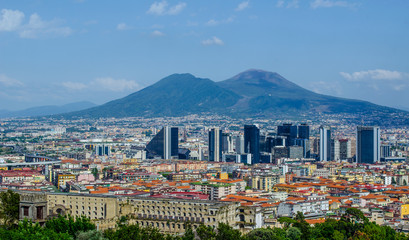 aerial view of centro direzionale business district in naples with mount vesuvius behind.