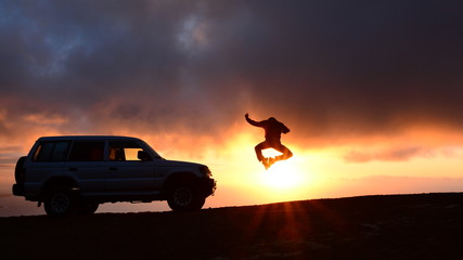 Man Jumping by a Car