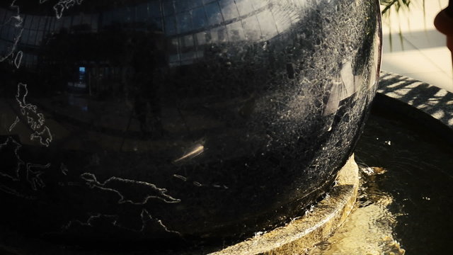 Stone globe spinning in the water