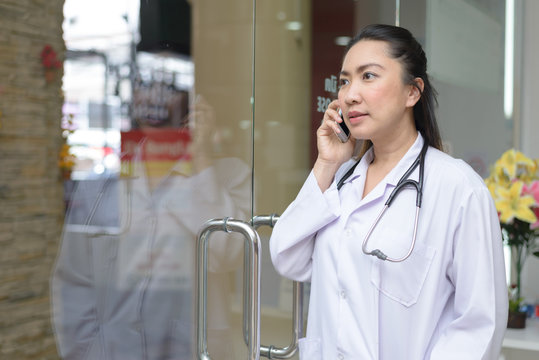 Asian Female Doctor Making A Phone Call