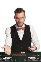 Attractive black jack dealer in his 20s with a beard, wearing a white shirt, black vest and a red bowtie, pointing at you. White background.